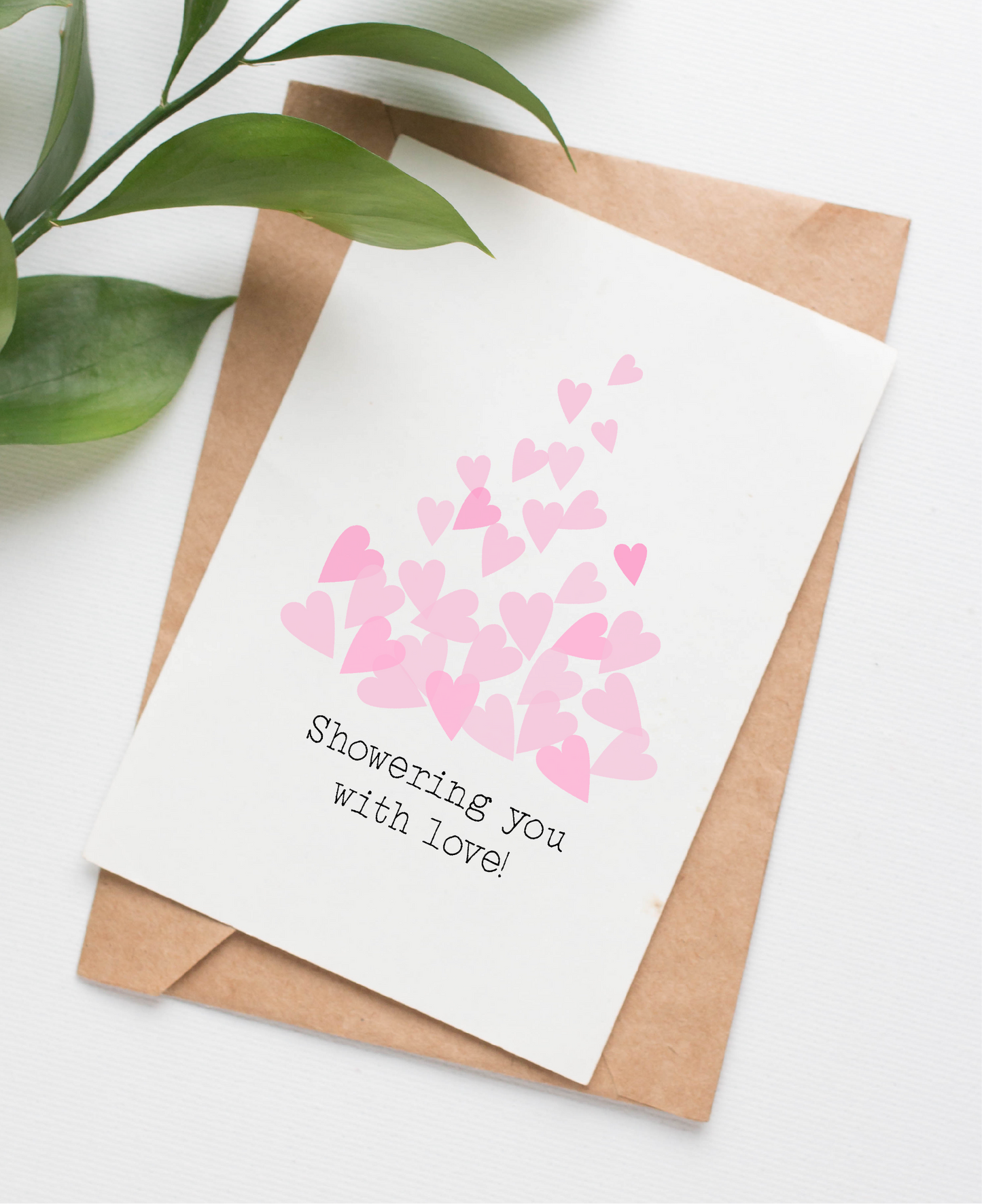 This greeting card is made in Canada. The card shows a cascade of pink hearts with the caption "Showering you with love"