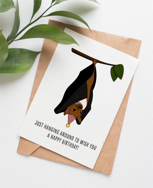 Canadian made birthday card with an illustrated bat and a caption that says "Just hanging around to wish you a happy birthday!"